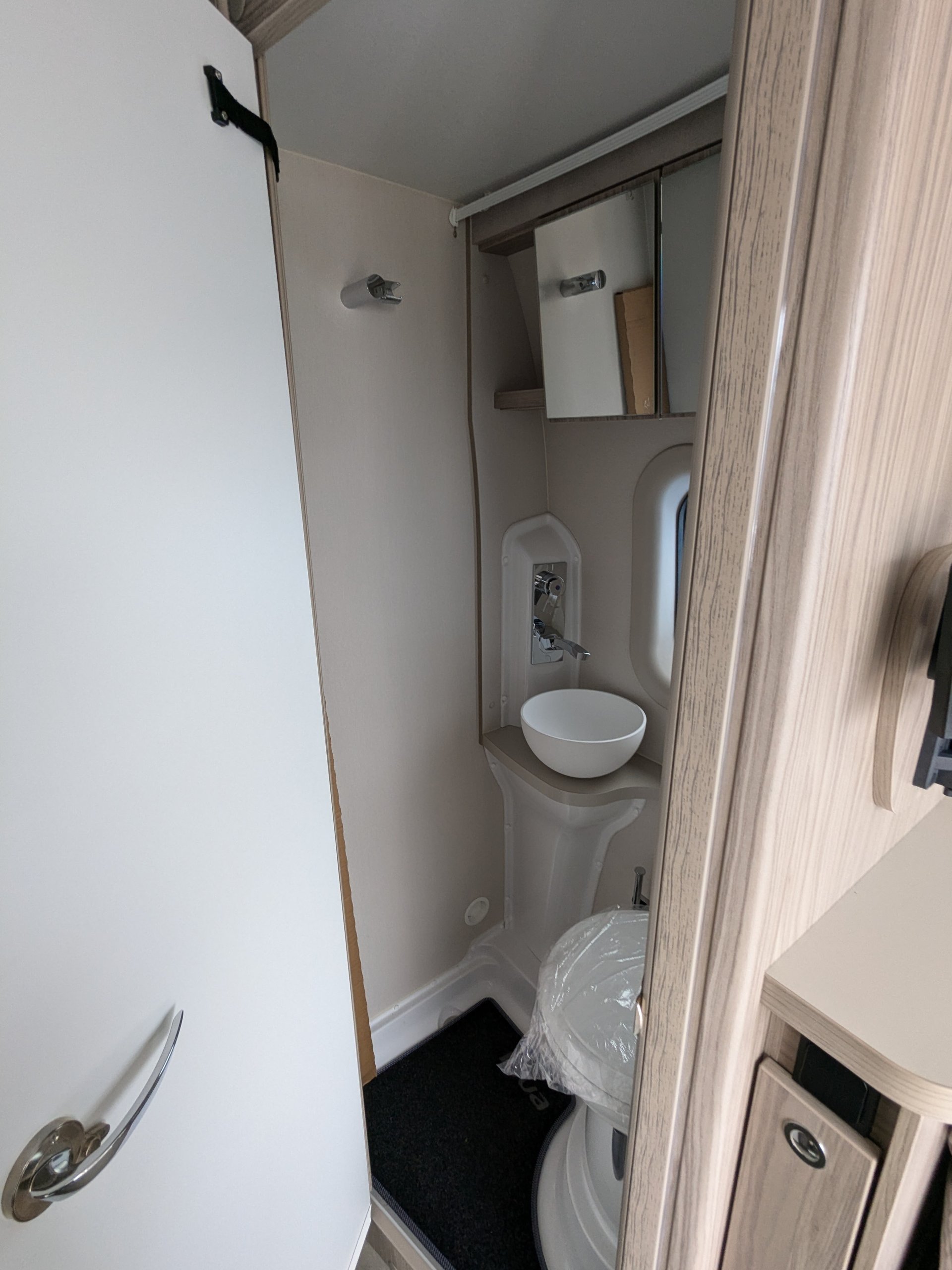 Vertical view of wet room washbasin, shower, and cassette toilet